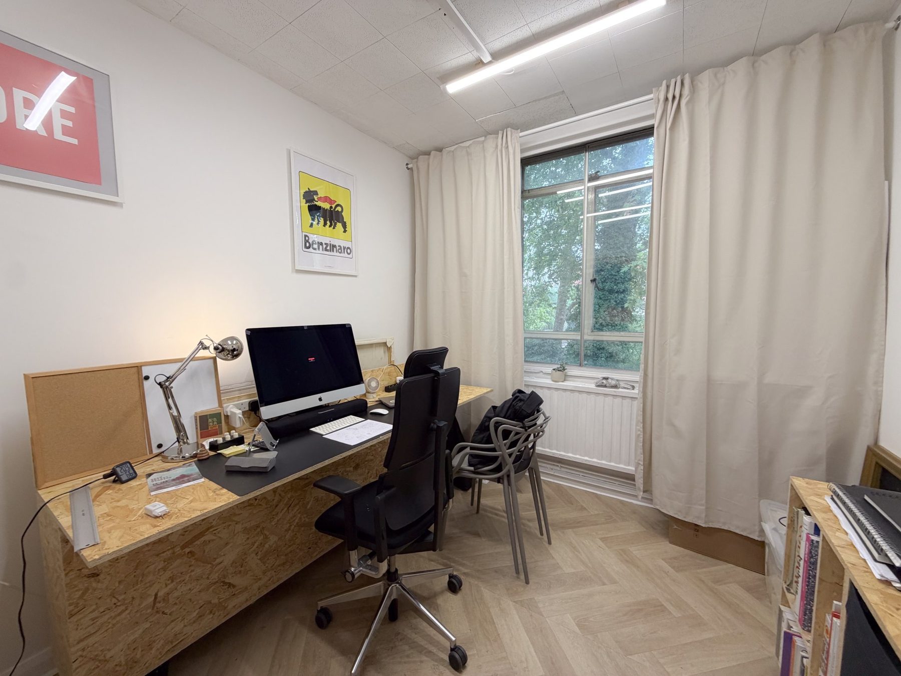 A furnished studio with a desk and computer