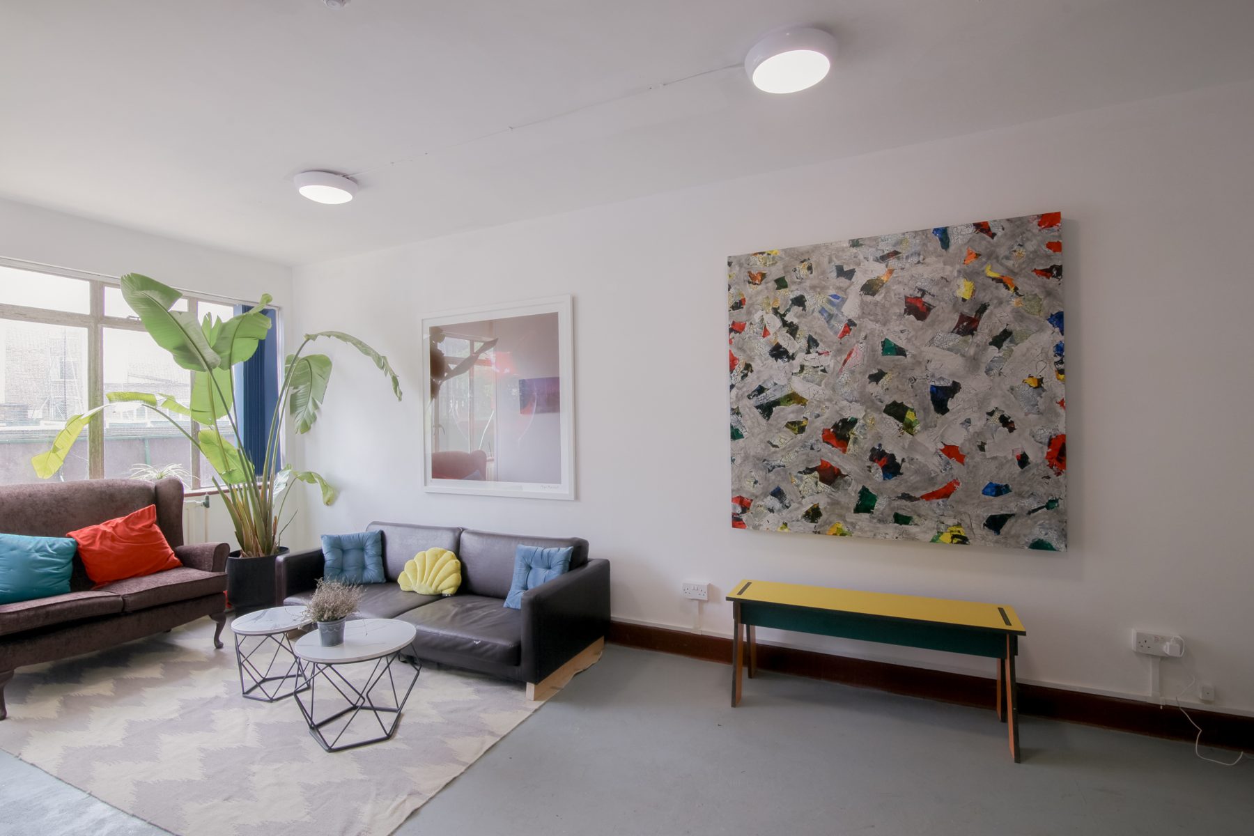 The shared lounge with sofas and artworks